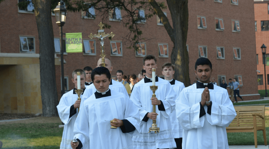 group of seminarians processes around campus